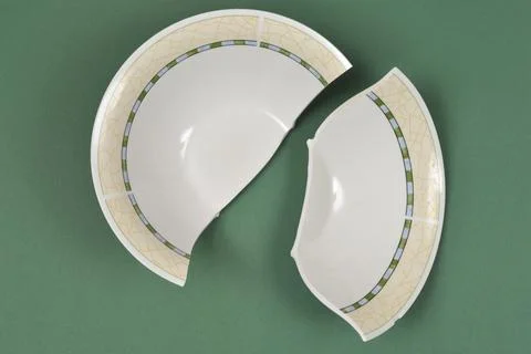 Broken Ceramic Bowl on Green Background Stock Photos