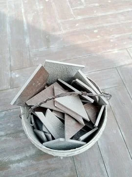 Broken Ceramic Pieces Collected in a Plastic Bucket 스톡 사진