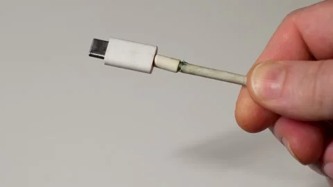 Broken charging cable, close-up. Hand holding frayed charging cable type C Stock Footage 296363169