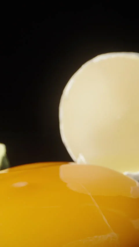 A broken chicken egg on a black mirrored... | Stock Video | Pond5