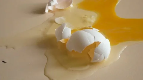 A broken chicken egg is on the table Stock Footage 218458025