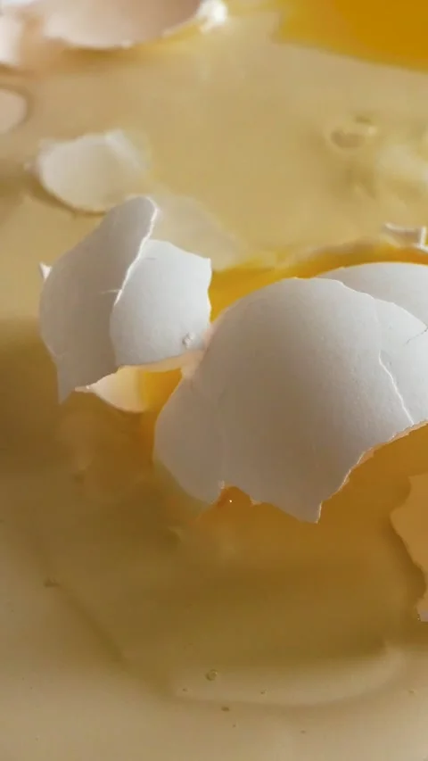 A broken chicken egg is on the table Stock Footage 308029031