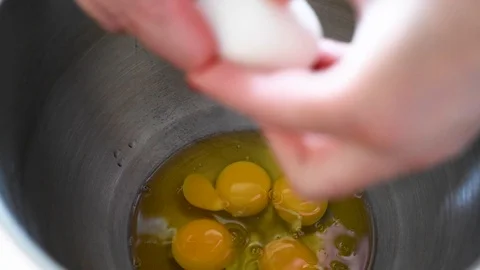 Broken chicken eggs in a transparent container for cooking Stock Footage 94758360
