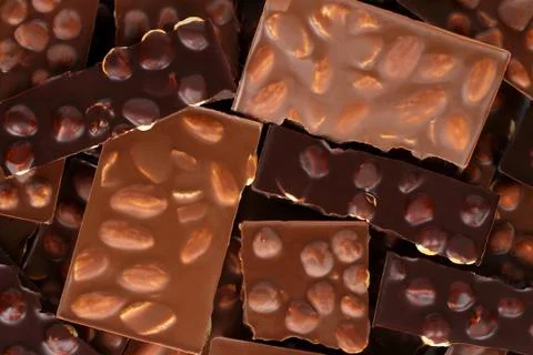 Broken chocolate bars with nuts background Stock Photos