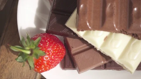 Broken chocolate bars on a table next to a chocolate cocktail Stock Footage 90417536