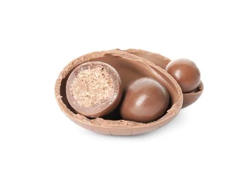 Broken chocolate Easter egg with candies on white background Stock Photos