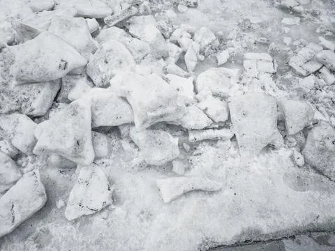 Broken chunks of dirty ice and melting snow. End of winter texture. Stock Photos