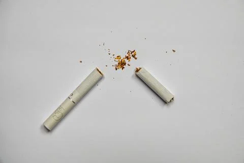 Broken cigarette on a white background. Stock Photos