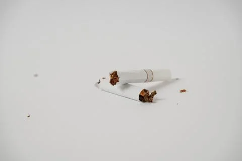 A broken cigarette on a white background Stock Photos