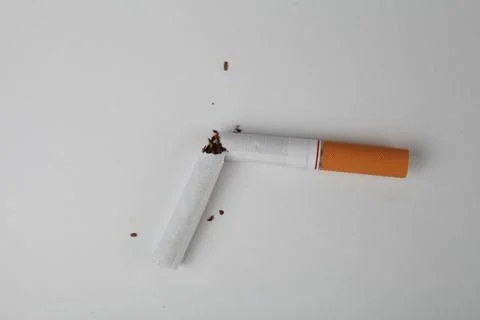 Broken cigarette on white background, top view Stock Photos