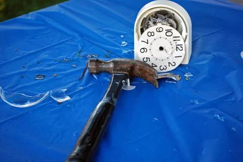 Broken clock with hammer Stock Photos