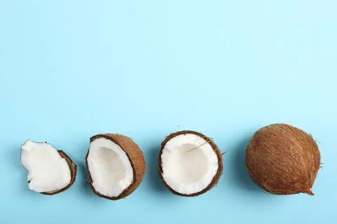 Broken coconut on a colored background. Stockfoto's