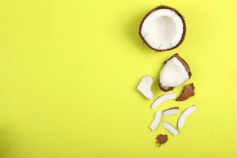 Broken coconut on a colored background. Stock-Fotos