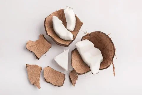 Broken coconut shell with white coconut meat on a white background Фото