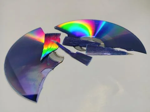 Broken compact disc on white background Stock Photos