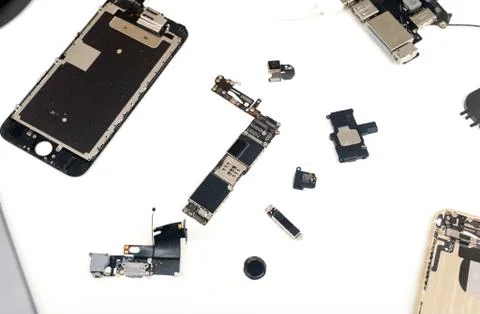 Broken components of an apple macbook ipad computer on a white background wit Stock Photos