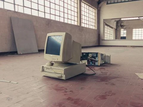 Broken computer abandoned in warehouse Stock Photos