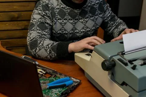 A broken computer and an old typewriter Stock Photos