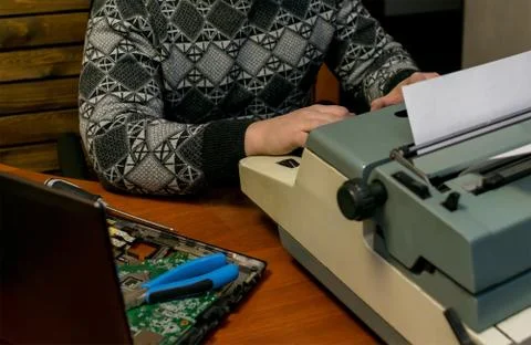 A broken computer and an old typewriter Stock Photos