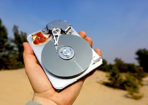 Broken computer hard disk in man hand Stock Photos