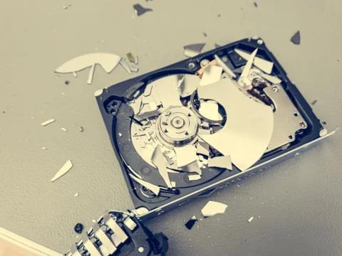 Broken computer hard disk on a table - complete data destruction. Foto stock
