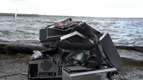 Broken computer parts, monitors and printers in front of nature landscape with a Stock Footage 92015734