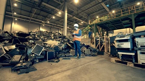 Broken computers are being observed by a male junkyard employee. Garbage, trash Stock-Footage 126061817
