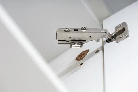 Broken concealed hinge on cabinet door, furniture fitting hardware Foto stock