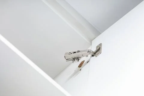 Broken concealed hinge on cabinet door, furniture fitting hardware Stock Photos
