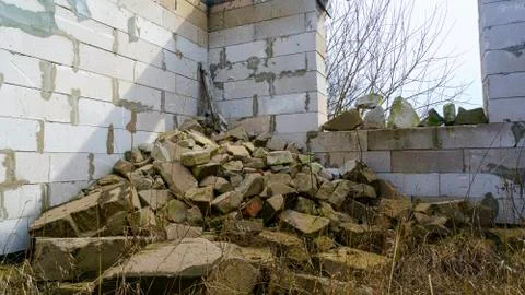 Broken concrete blocks and bricks on white wall background. Construction debr 写真素材