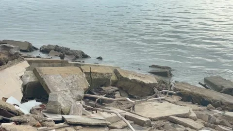 Broken Concrete Slabs and Debris on a Cloudy Seashore Stock Footage 330145500