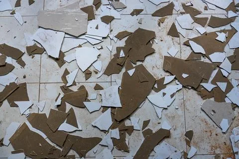 Broken construction debris and tile fragments on white floor Stock Photos