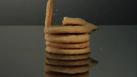 Broken cookie falling onto stack of cookies Stock Footage 327180056