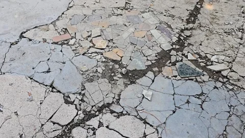 Broken cracked concrete ground surface texture high angle close up view Video stock 342585796