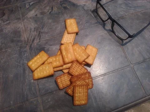 Broken crackers on gray surface. Stock Photos
