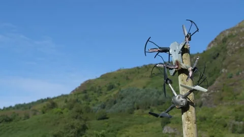Broken crashed drones stuck on a stick Stock Footage 219492250