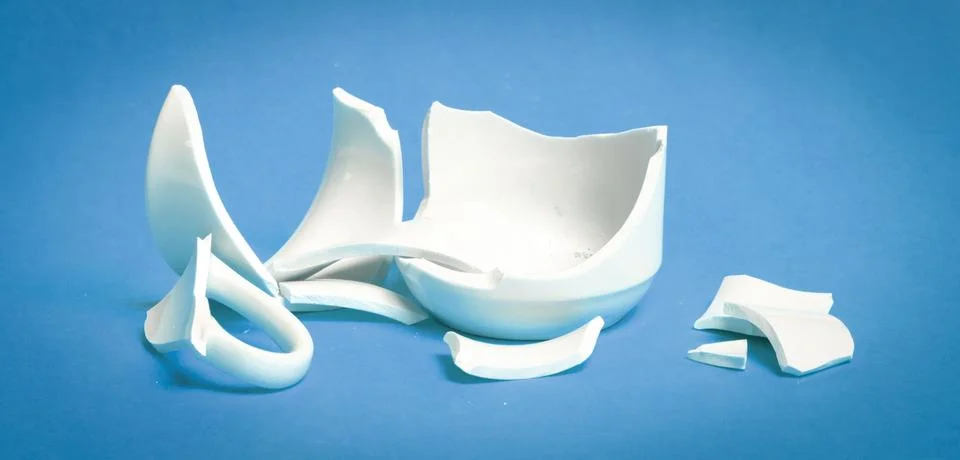 Broken cup isolated on a solid background Stock Photos