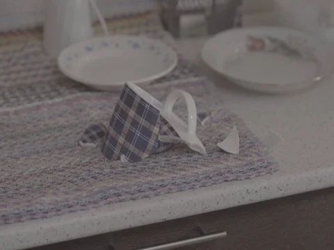 Broken cup, shattered cup, damaged mug on the kitchen table, kitchen. Closeup Video stock 76950401