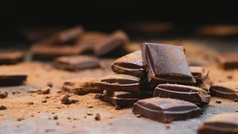 Broken dark chocolate bars on black background, stack of chocolate pieces Stock Footage 149318687