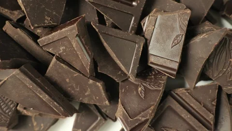 Broken dark chocolate pieces dolly shot Stock Footage 335435600
