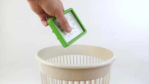 A broken desk clock is thrown into the trash can. Disposal of household waste Stock Footage 271665988