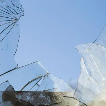Broken dirty glass in blue background Stock Photos