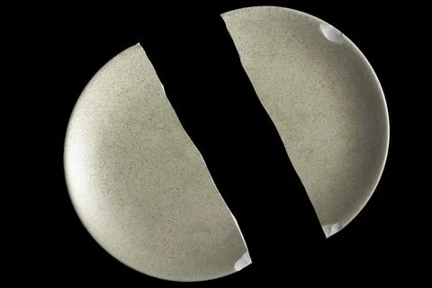 A broken dish on a black background Foto stock