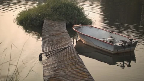 Broken Dock and an Worn Motor Boat Stock Footage 89781857