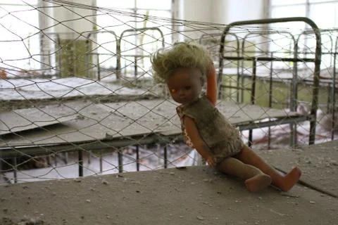 Broken doll during evacuation after Chernobyl catastrophe from Pripyat Stock Photos