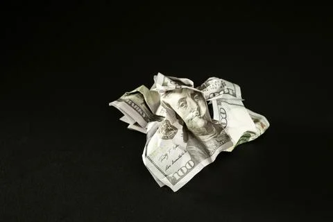 Broken dollar isolated on black background. Concept of the victory of Stock Photos