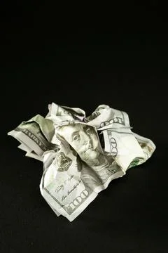 Broken dollar isolated on black background. Concept of the victory of Stock Photos