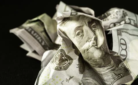 Broken dollar isolated on black background. Concept of the victory of Stock Photos