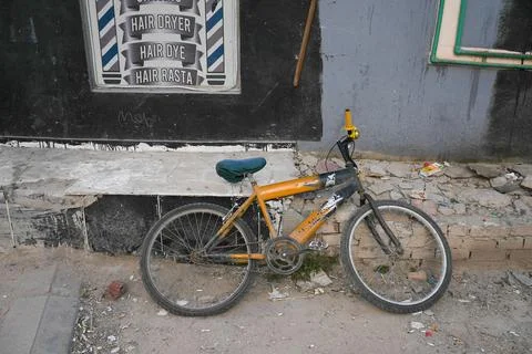 Broken down abandoned bicycle in poor neighbourhood Stock Photos