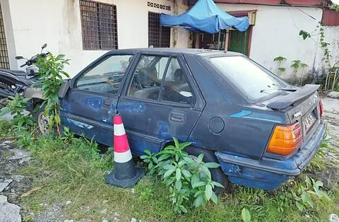 Broken down car left abandoned in yard Stock Photos